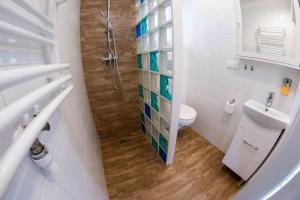 a white bathroom with a toilet and a sink at Piaskowa Polana in Dębki +20 photos