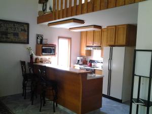a kitchen with a counter and a kitchen with a refrigerator at A Relaxing Getaway SolDuc 1 in Forks