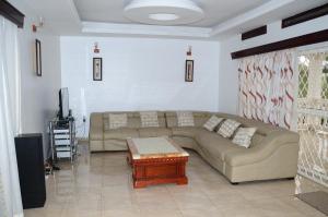 a living room with a couch and a coffee table at Muyenga Luxury Vacation Home in Kampala