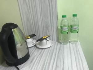 a television and two bottles of water on a table at Kimal Hotel Kamunting in Taiping