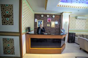 a man standing at a bar in a restaurant at istanbul duhok hotel in Istanbul