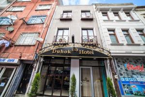 a hotel with a sign that reads duth hotel at istanbul duhok hotel in Istanbul