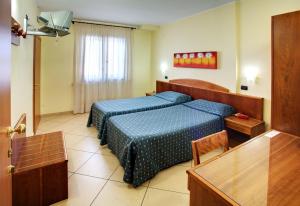 Postel nebo postele na pokoji v ubytování Lo Scacciapensieri Hotel & Restaurant + 19 fotografií