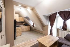 a living room with a couch and a table at Apartment Doyran in Ruse