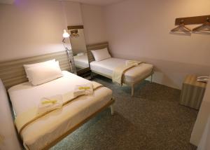 Postel nebo postele na pokoji v ubytování 1010 Hotel + 4 fotografie
