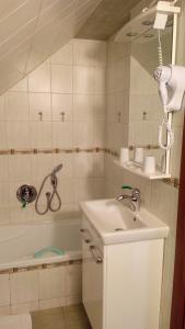 a bathroom with a sink and a bath tub at Apartments U Kašny in Kadaň