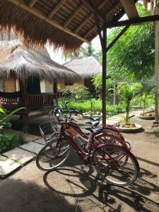 a group of bikes parked under a hut at Meno Madia Bungalows in Gili Meno