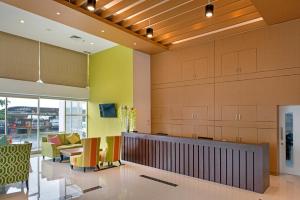 a lobby with colorful chairs and a waiting area at Whiz Prime Hotel Megamas Manado in Manado