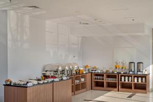 a kitchen with a lot of food on display at Whiz Prime Hotel Megamas Manado in Manado