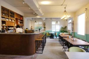 a restaurant with a bar with tables and chairs at Shen Nong Village in Yilan City