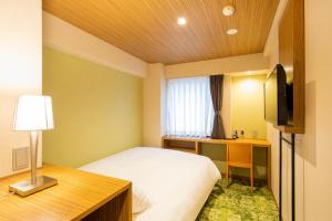 Postelja oz. postelje v sobi nastanitve Fukuoka Toei Hotel