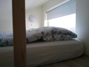A bed or beds in a room at Vatnsás 10