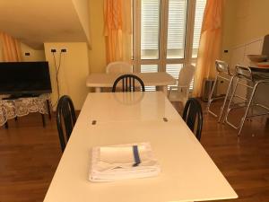 a white table with a napkin on top of it at Le Palme Residenza Estiva in Martinsicuro