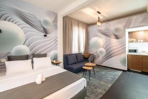 a hotel room with a bed and a chair at 27Montefiore - Urban ApartHotel TLV in Tel Aviv