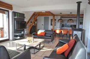 a living room with a couch and a table at La Coline in Somme-Leuze