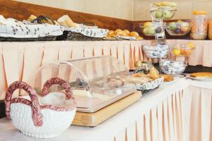 a buffet with bread and pastries on a table at Hotel Alameda in Zarautz