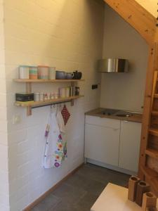 a kitchen with a sink and a counter in a room at drunter-drueber-Maisonette-Ferienwohnung-Luebecker-Bucht in Scharbeutz +3 photos