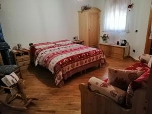 a bedroom with two beds and a couch at B&B Casa Delle Fate in Campodenno
