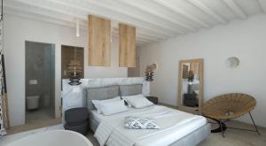 um quarto branco com uma cama e uma cadeira em Apiro Mykonos em Míconos