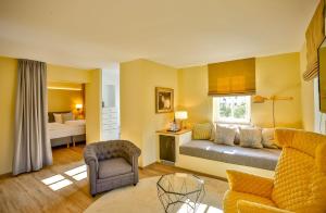 a living room with a couch and a bed at Posthotel Alexander Herrmann in Wirsberg