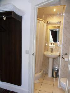 a bathroom with a sink, toilet and shower at Blossom Guest House in Edinburgh