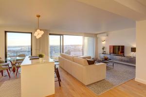 a living room with a couch and a table at Luxury Graça Apartment The Most Amazing View of Lisbon in Lisbon