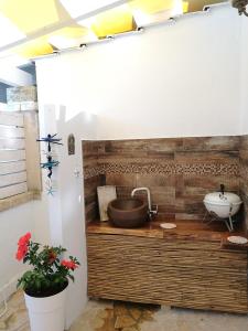 a bathroom with a sink on a wooden counter at Beach House Salento in Nardò +69 photos