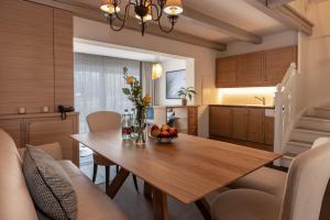 a kitchen and dining room with a wooden table at VILA VITA Pannonia in Pamhagen