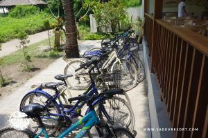 a row of bikes parked next to a fence at Sadev Resort in Gili Trawangan