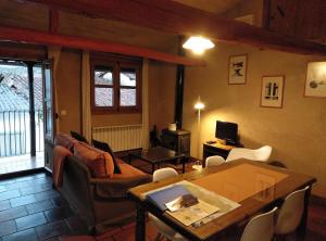 a living room with a couch and a table at La Herrera lll in San Esteban de la Sierra