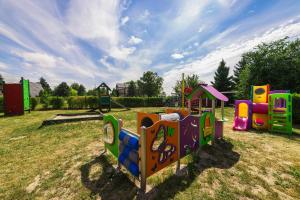 a playground with several play equipment in a field at Lech Resort & Spa in Łeba