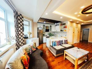 a living room with a couch and a table at Top Tour & Guesthouse Mongolia in Ulaanbaatar