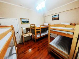 a room with three bunk beds in a room at Top Tour & Guesthouse Mongolia in Ulaanbaatar