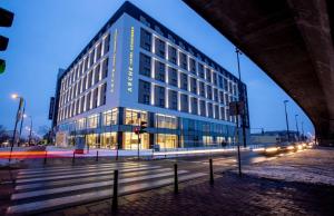 a large building on a city street at night at Arche Hotel Krakowska in Warsaw