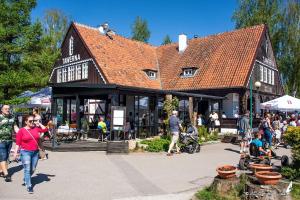 a group of people walking in front of a building at Siwa Czapla in Giżycko