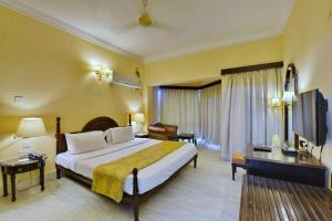Postel nebo postele na pokoji v ubytování Swosti Palm Resort Gopalpur