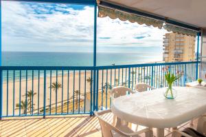 a balcony with a table and a view of the beach at MyFlats Azul in El Campello