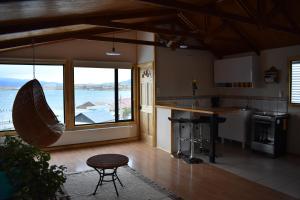 a kitchen with a view of the ocean in a house at Cumbres Apart in Puerto Natales