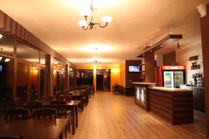 a restaurant with tables and chairs and a bar at Perperеshka River Villas in Stremtsi +52 photos