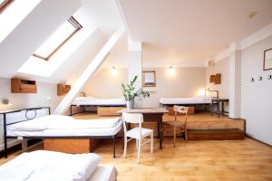 a room with beds and a table and chairs at Sir Toby's Hostel in Prague