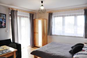 Posteľ alebo postele v izbe v ubytovaní Apartamenty JSZI