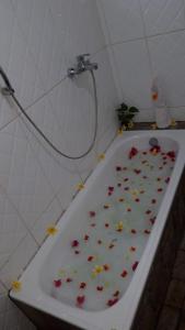 a bath tub with flowers on it in a bathroom at Pele's Place in Sabong