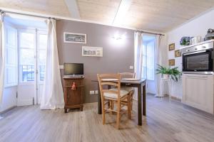a kitchen and dining room with a table and a television at Il borghetto di Torno in Torno