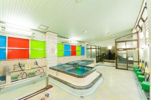 a large bathroom with a tub with colorful walls at Guesthouse Mokumoku in Osaka