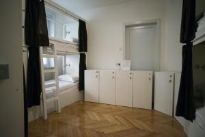 a room with white cabinets and a bunk bed at The Good Place Hostel in Sarajevo