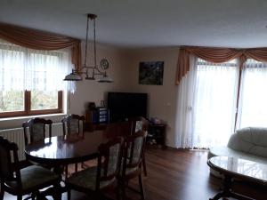 a living room with a table and chairs and a couch at Ferienhaus "Werrablick-Frankenroda" in Frankenroda