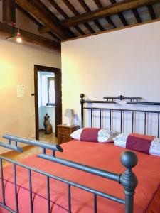 a bedroom with a large bed with a metal frame at Agriturismo Podere Pescara in Orvieto