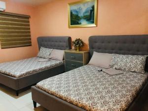 A bed or beds in a room at Luzville Residences C10