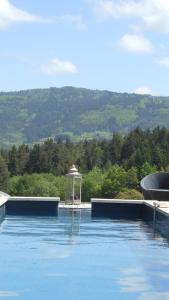 a swimming pool with a gazebo in the water at Domaine de Sault in Dore-lʼÉglise