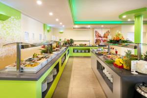 
a kitchen filled with lots of different types of food at Hotel Tropical Park in Callao Salvaje
